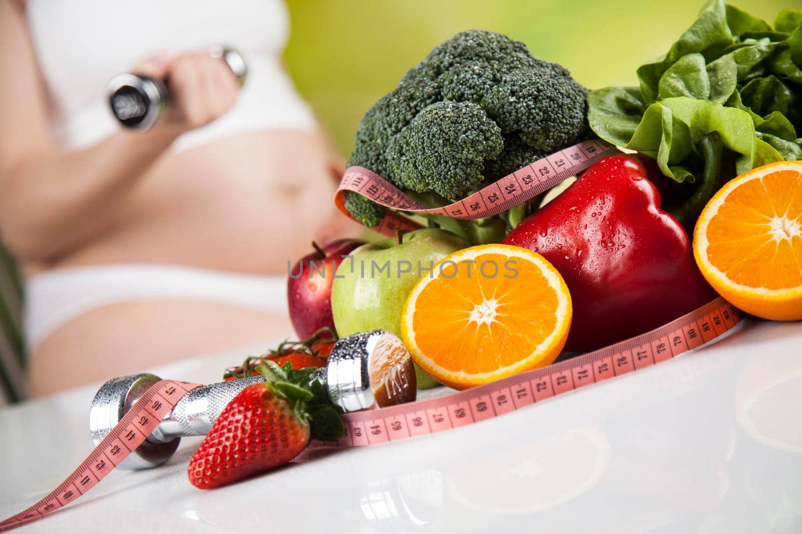 Pregnant woman with fruit and vegetables