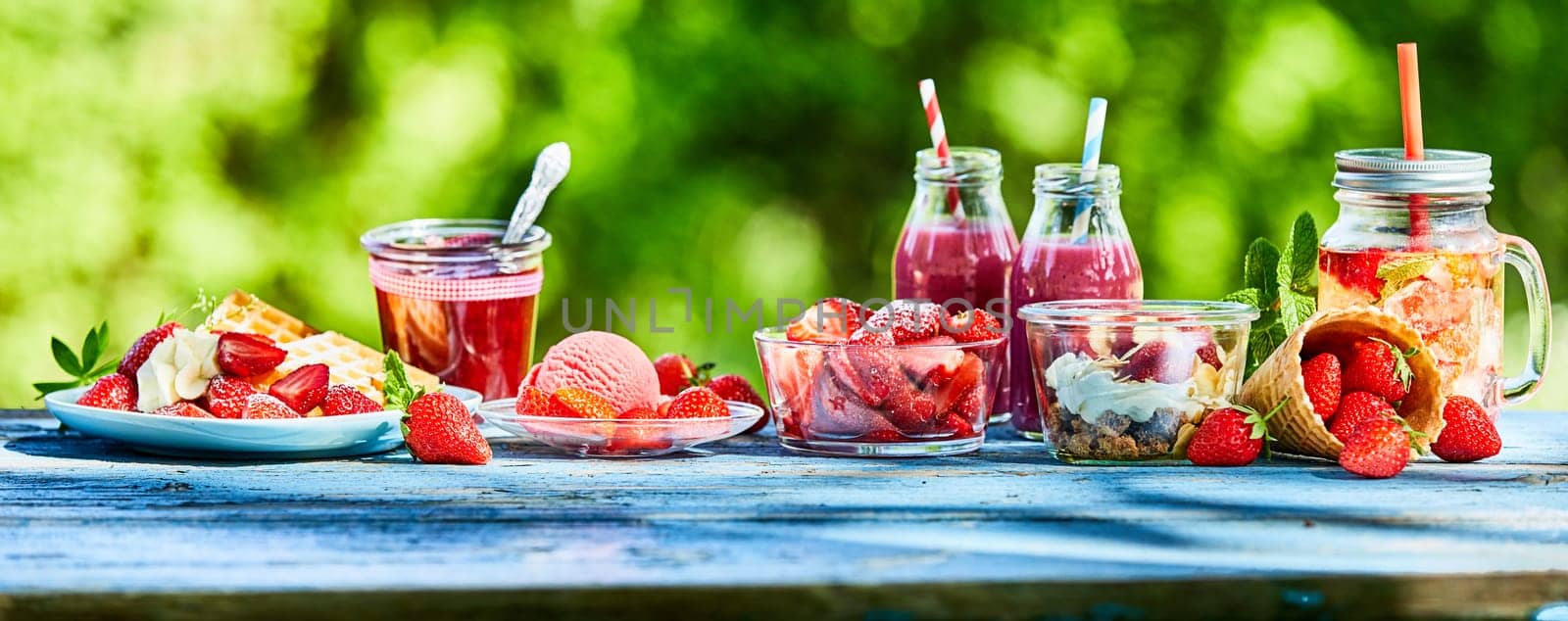 Summer strawberry garden food panorama banner. Delicious berry menus and desserts, punch bowl and ice cream and smoothies outdoors for advertising.