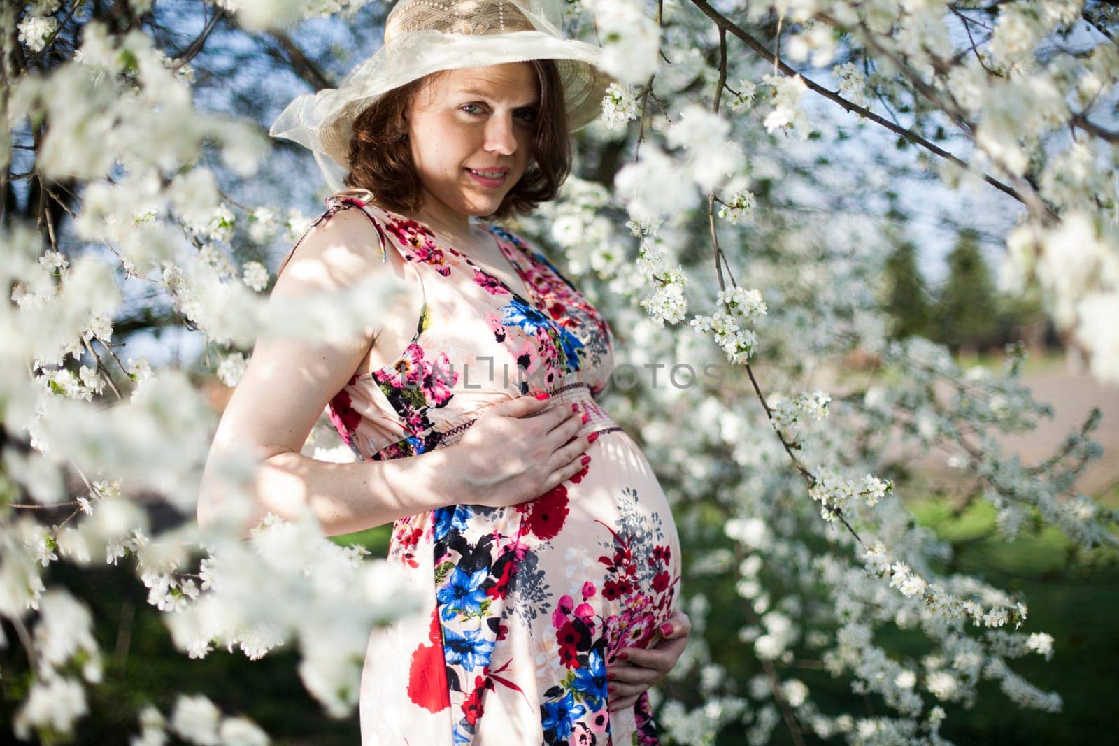 Spring, Young beautiful pregnant woman in the Orchard
