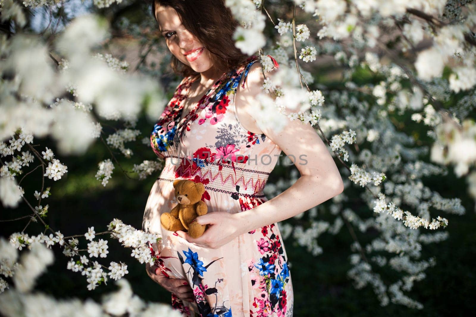 Beautiful pregnant woman relaxing outside in the Orchard