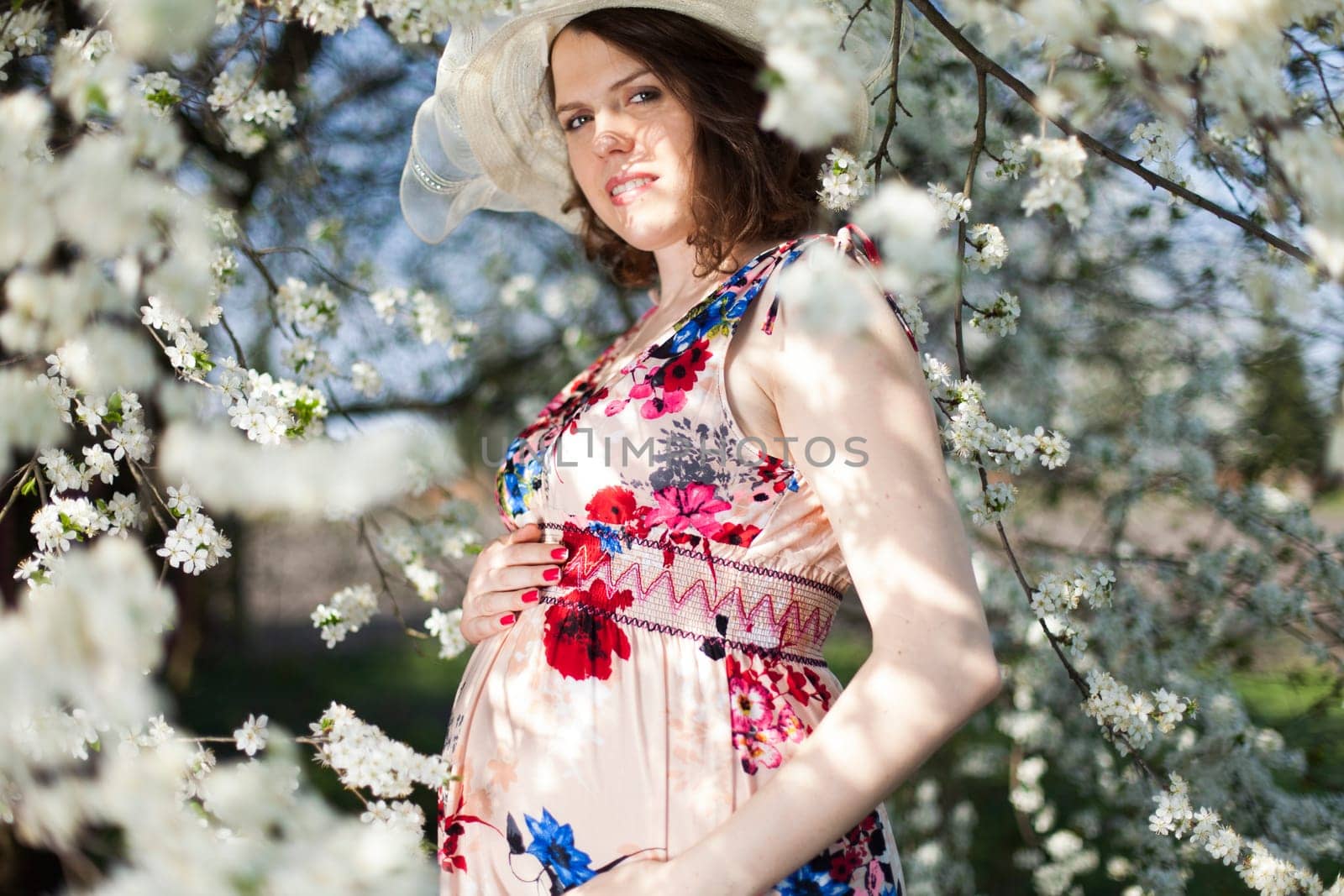 Spring, Young beautiful pregnant woman in the Orchard