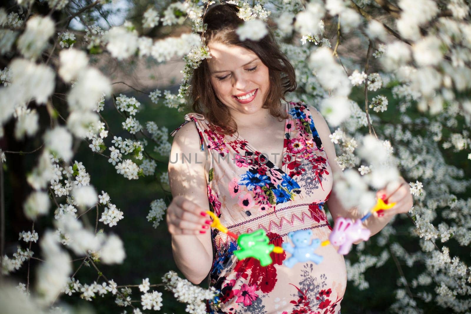 Beautiful pregnant woman relaxing outside in the Orchard