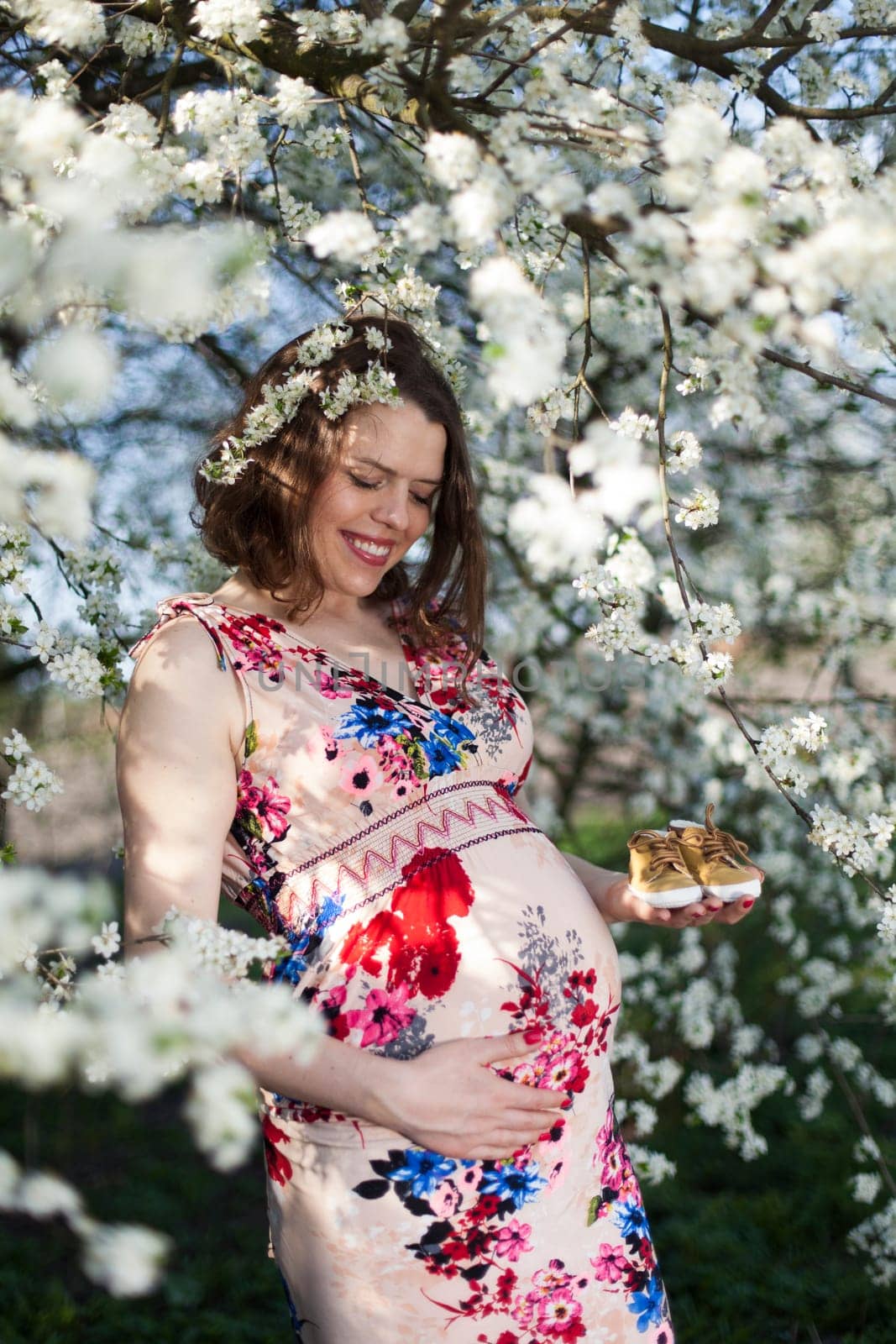 Spring, Young beautiful pregnant woman in the Orchard