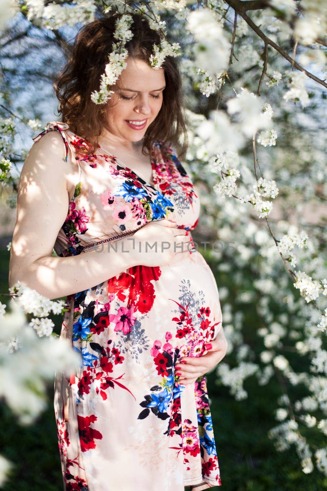 Spring, Young beautiful pregnant woman in the Orchard