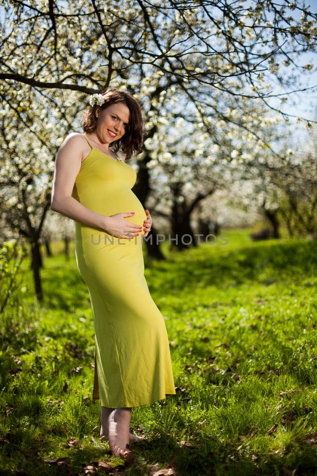 Blooming garden, Beautiful pregnant woman