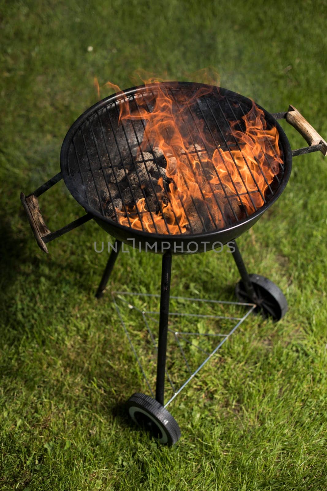 Barbecue grill with fire on nature, outdoor, close up