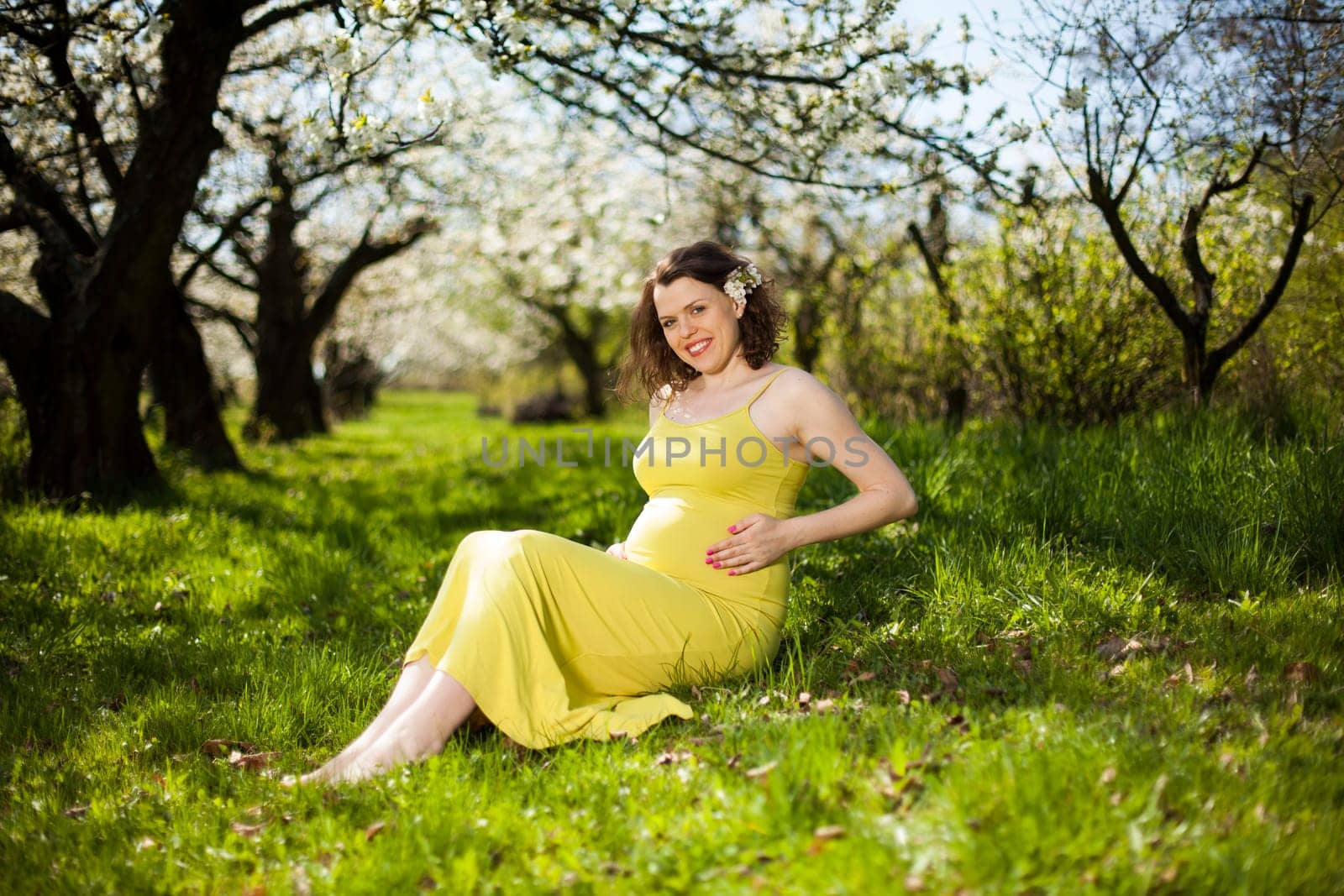 Spring, Young beautiful pregnant woman in the Orchard