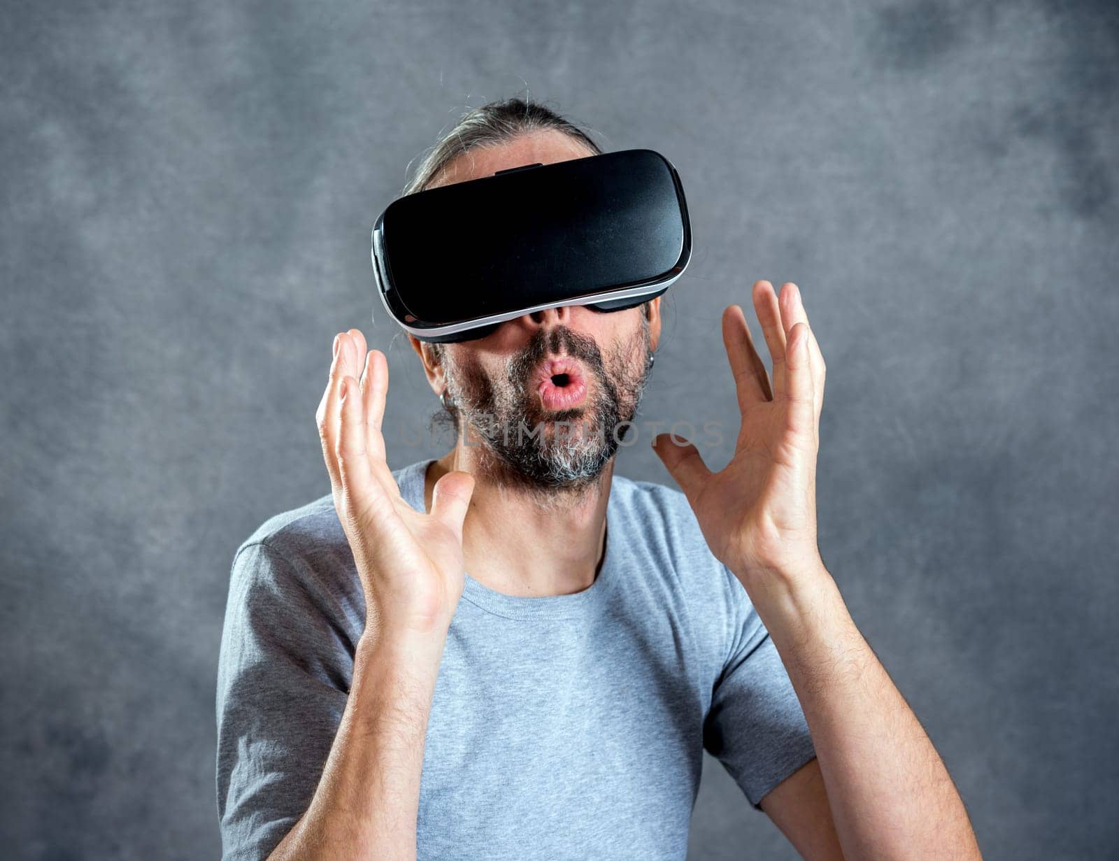 young man with virtual reality glasses looking surprised