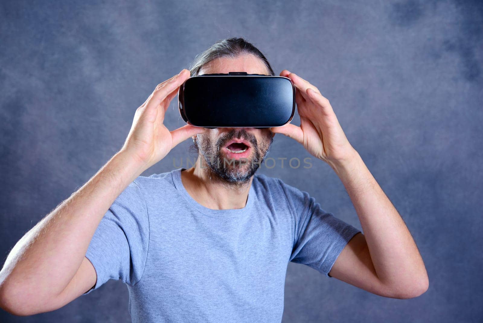 young man with virtual reality glasses looking surprised