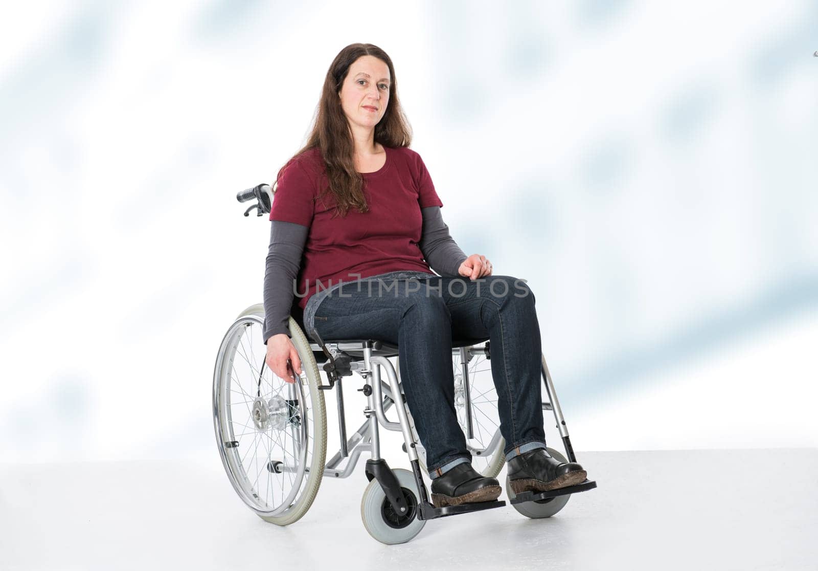 young woman in wheelchair in front of bright  background