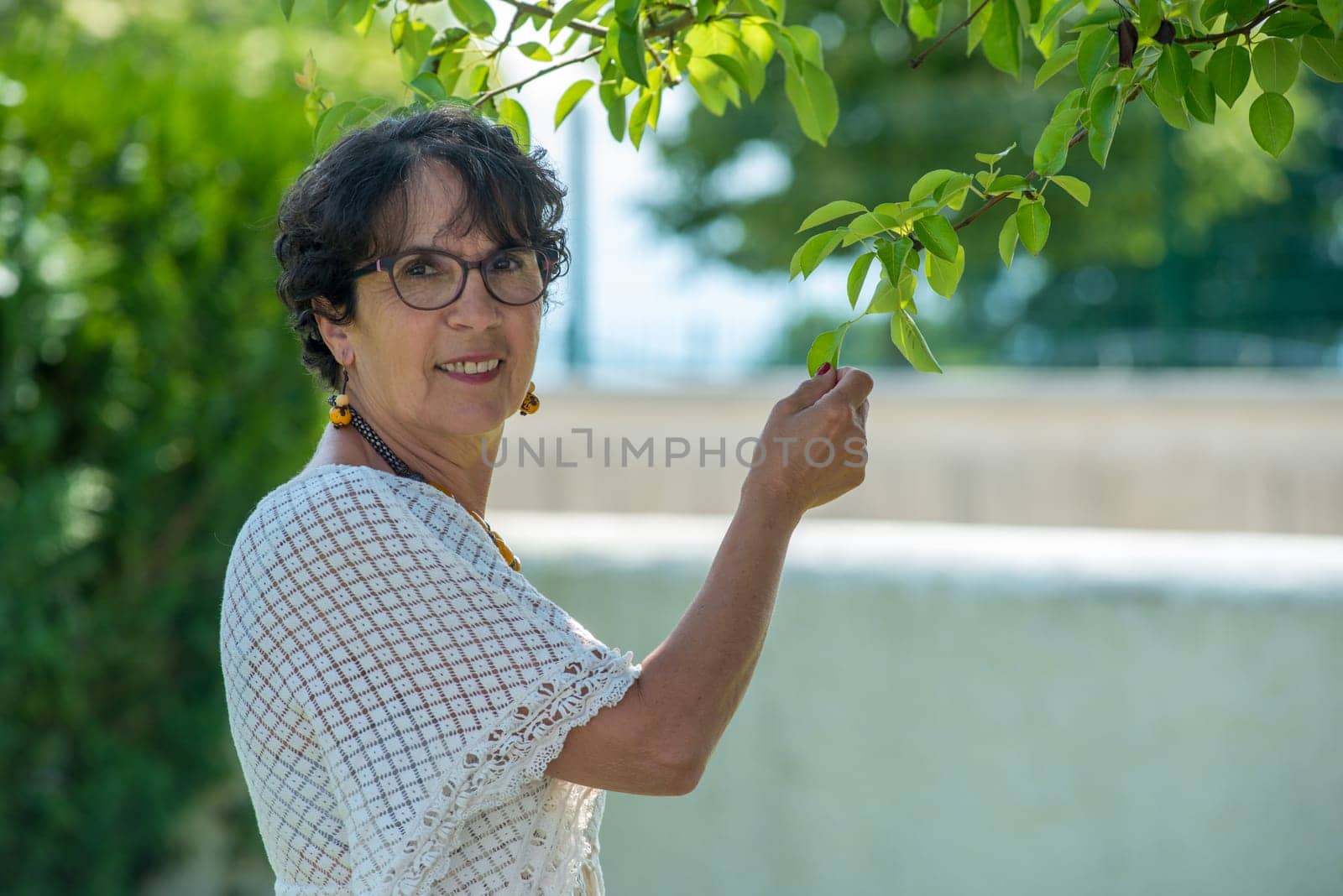 a portrait of a beautiful senior woman in the garden
