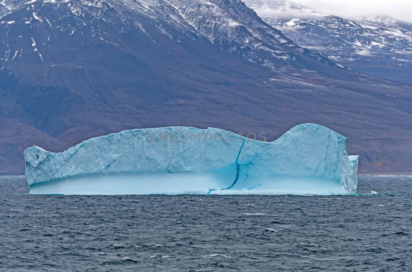 Blue Iceberg along a Remote Coast of Greenland along the Nugssuaq Peninsula