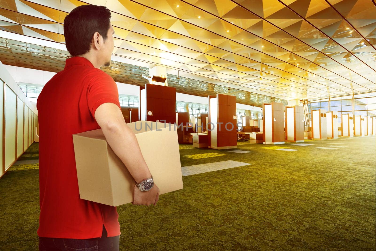 Attractive asian delivery man bring package to deliver on modern building