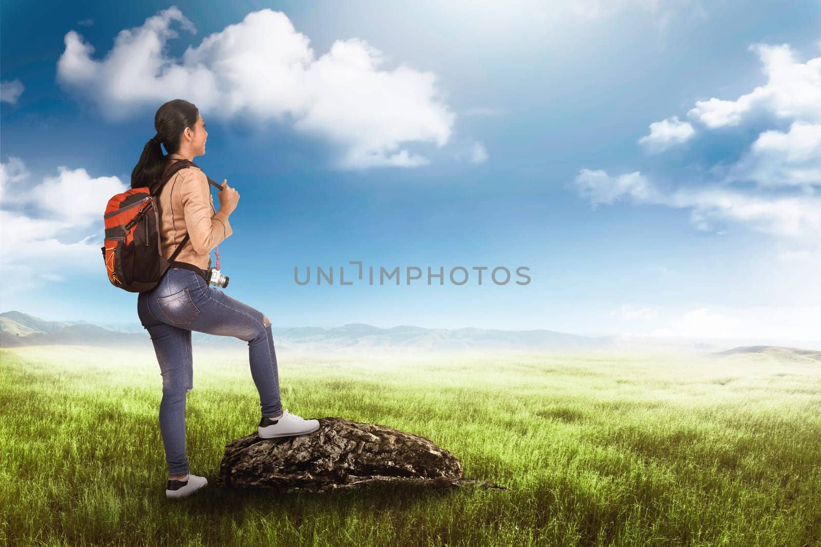 Happy asian tourist woman with bag on her back enjoy the view at meadow field