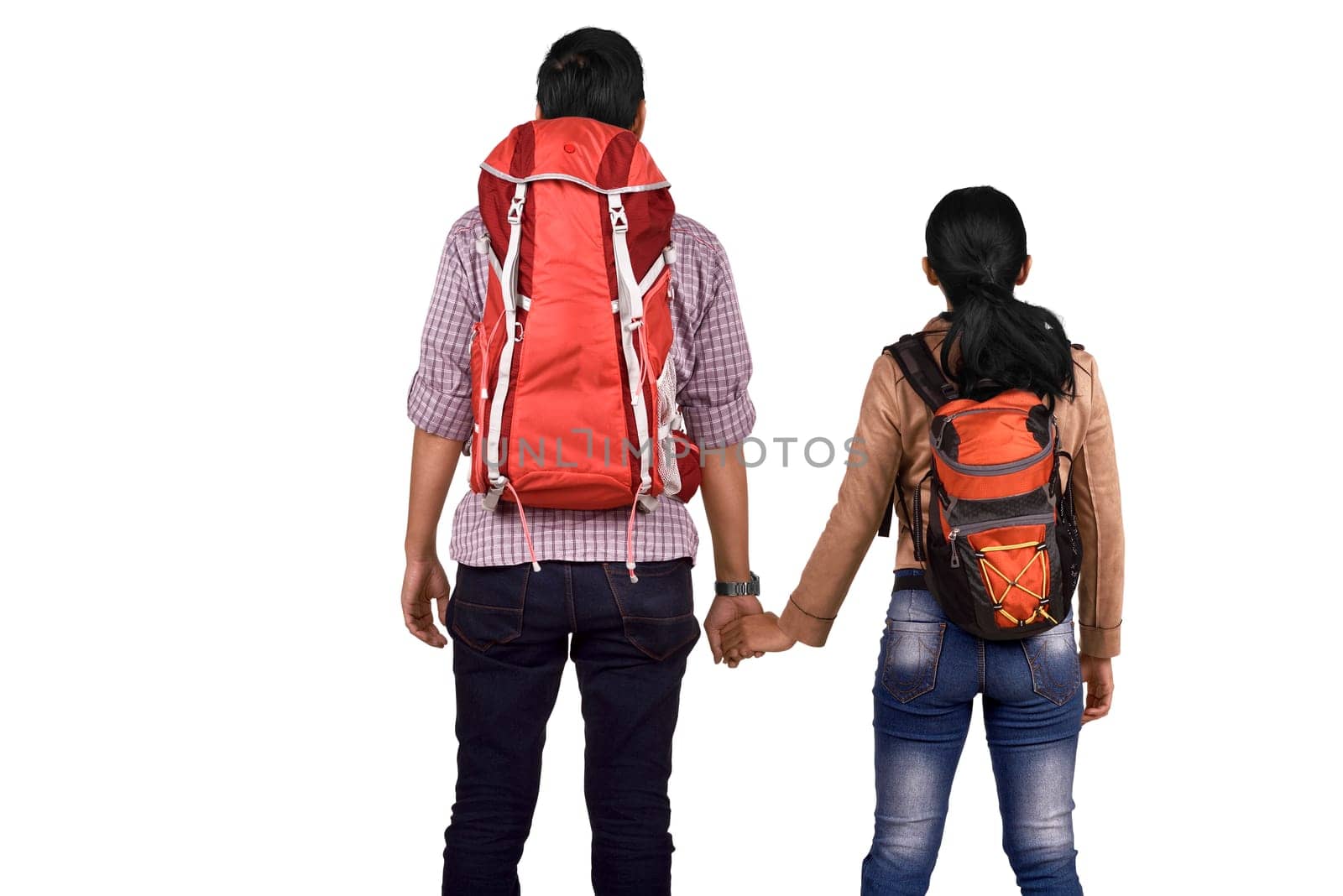 Rear view of asian couple with backpack holding hands posing isolated over white background