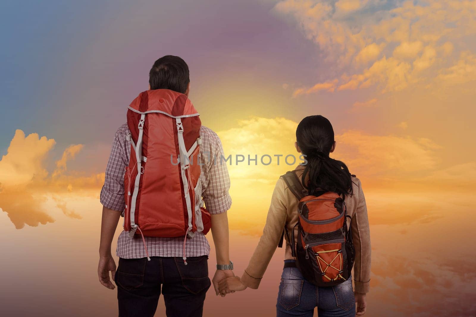 Young asian couple enjoying scenery together with dramatic sky background