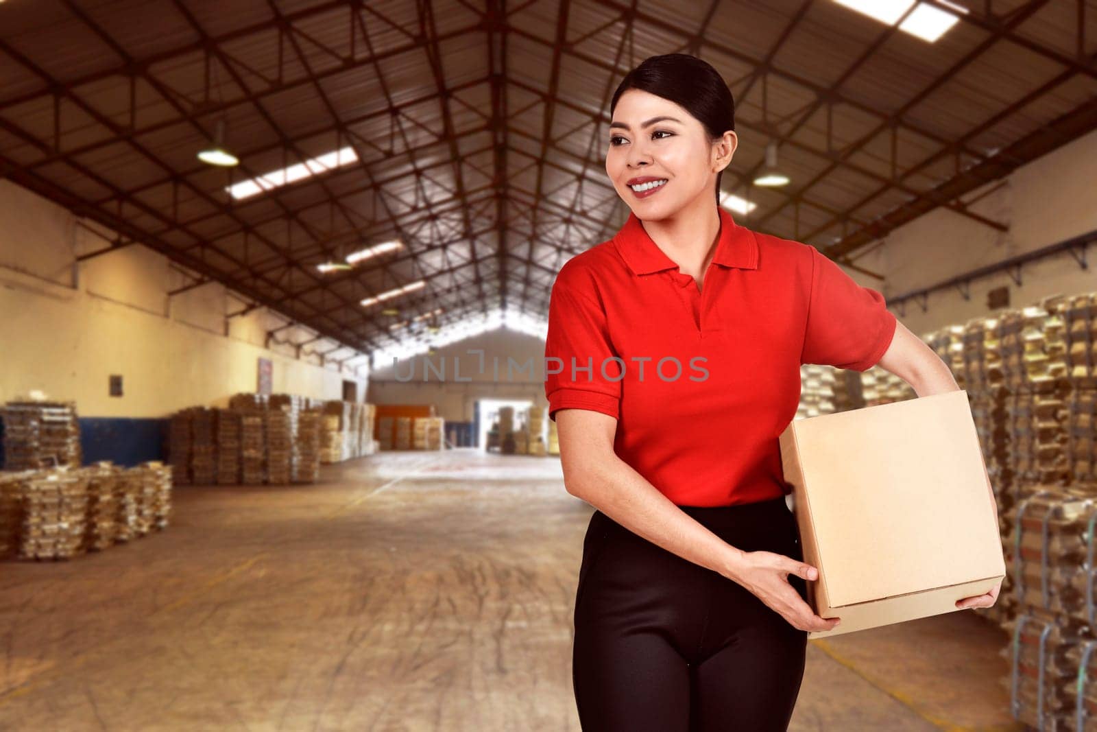 Pretty asian courier woman bring the package on the warehouse
