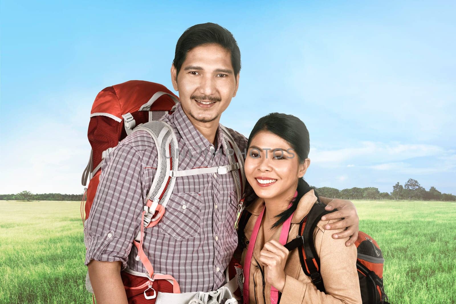 Smiling asian traveler couple relaxing and enjoying the trip at nature