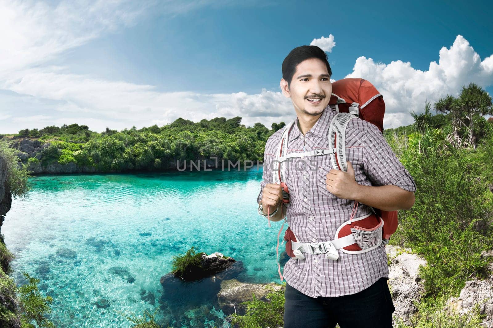 Cheerful asian backpacker enjoying nature at travel destination