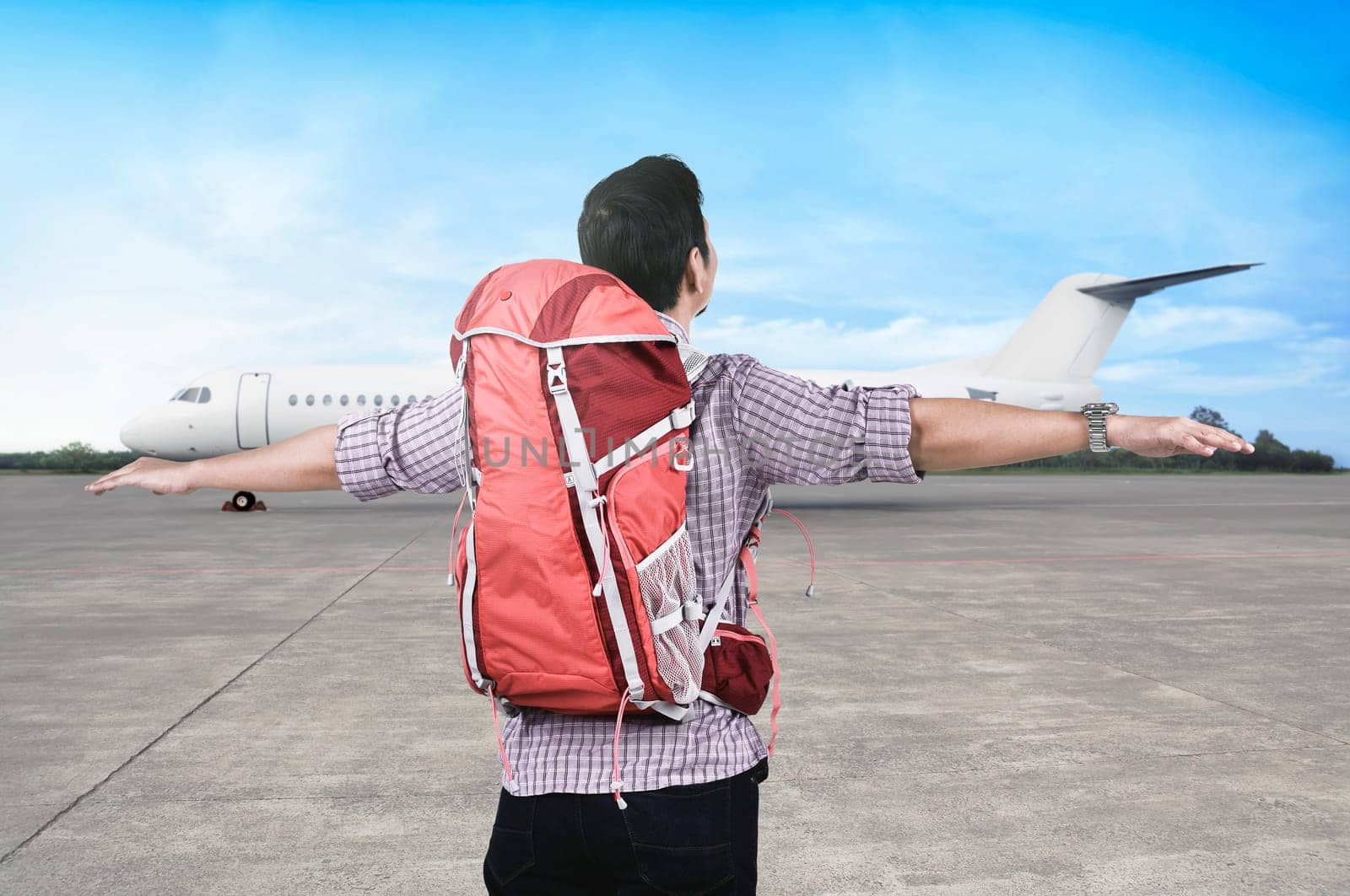 Happy asian traveler with backpack enjoying the trip by a plane