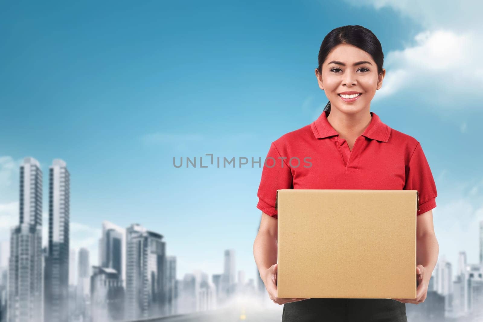Beautiful asian delivery woman delivering parcel on the city