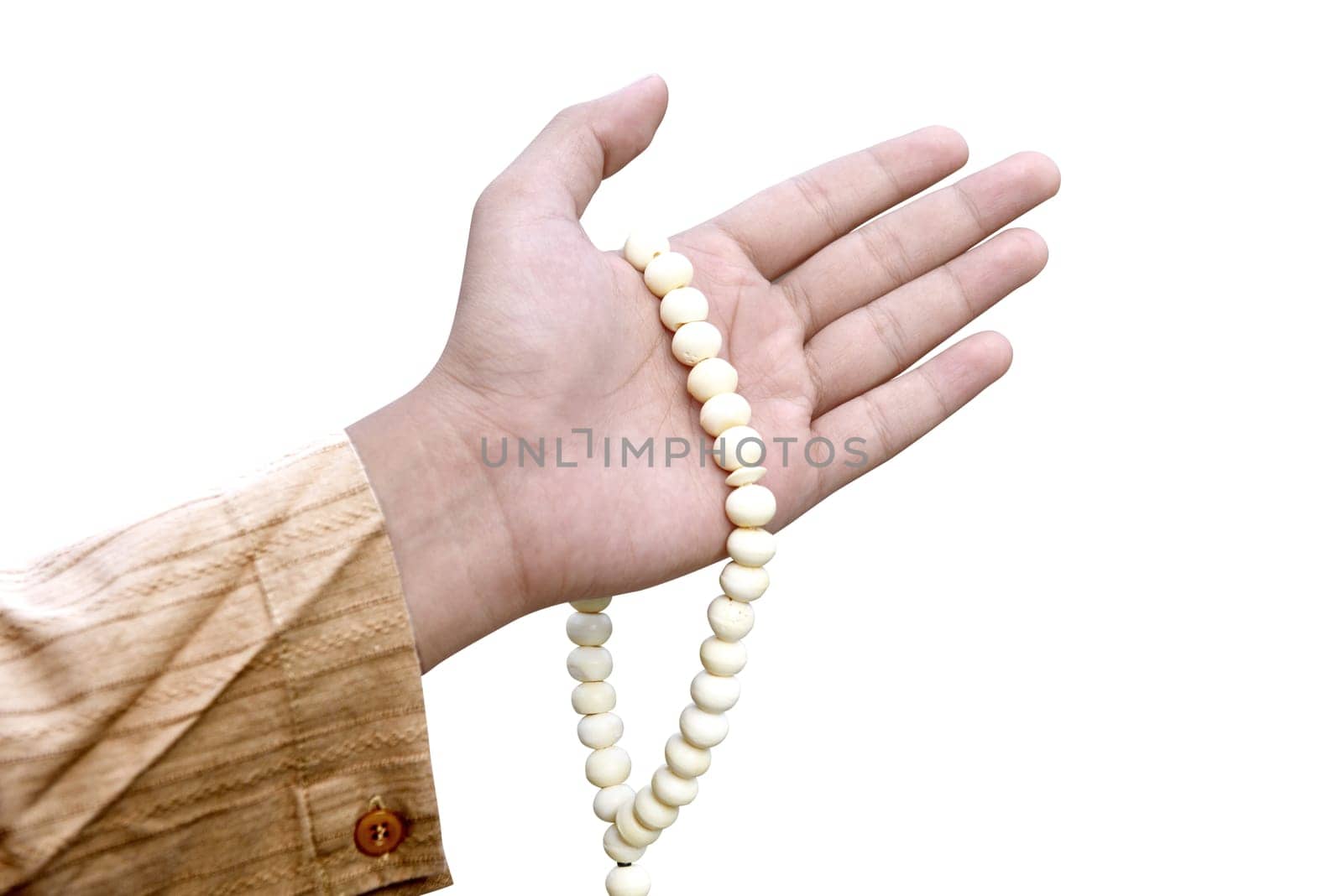 Muslim man holding prayer beads isolated over white background
