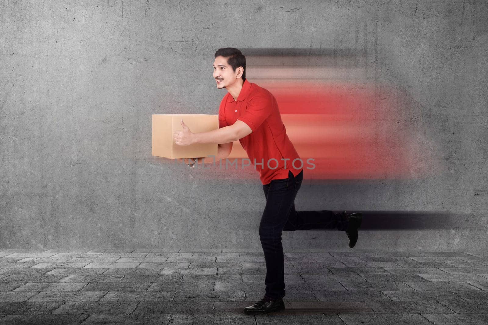 Handsome asian courier man delivering package on the urban street