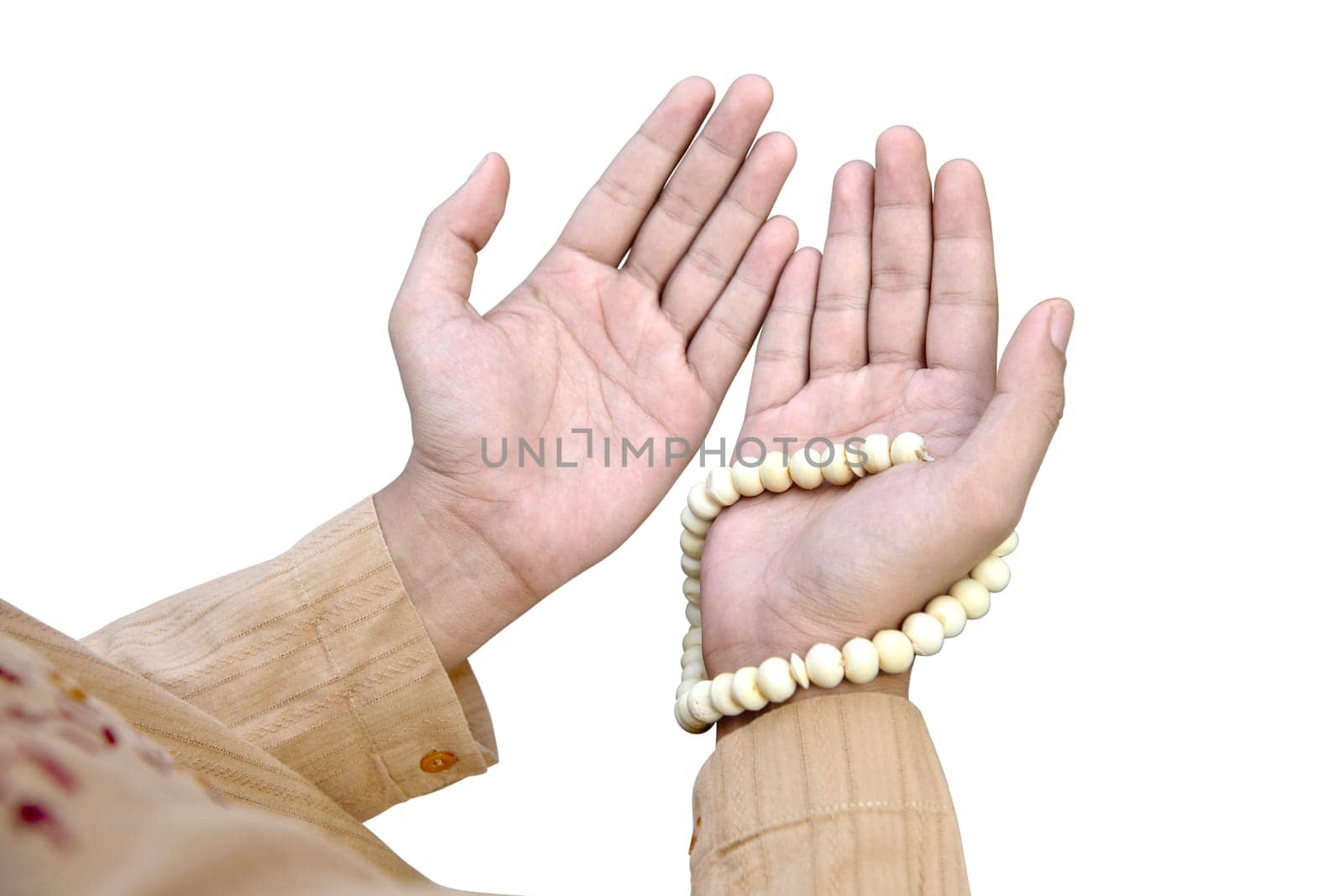 Muslim man praying with prayer beads isolated over white background