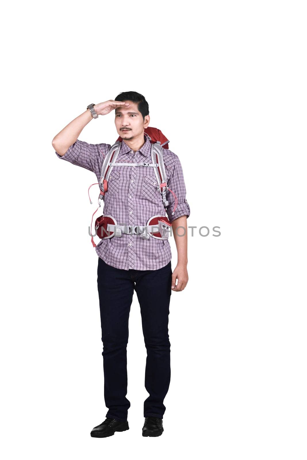 Portrait of asian tourist with backpack looking around posing isolated over white background
