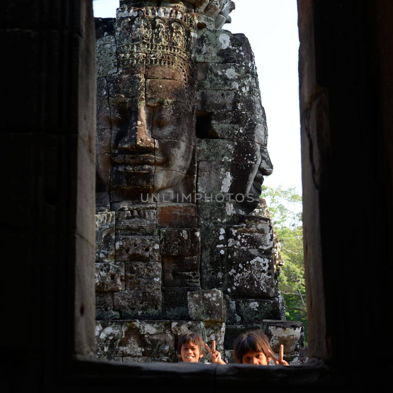 Stone face at the Bayon Temple the Tempel Ruins of Angkor Thom in the Temple City of Angkor near the City of Siem Reap in the west of Cambodia.  Cambodia, Siem Reap, April 2014