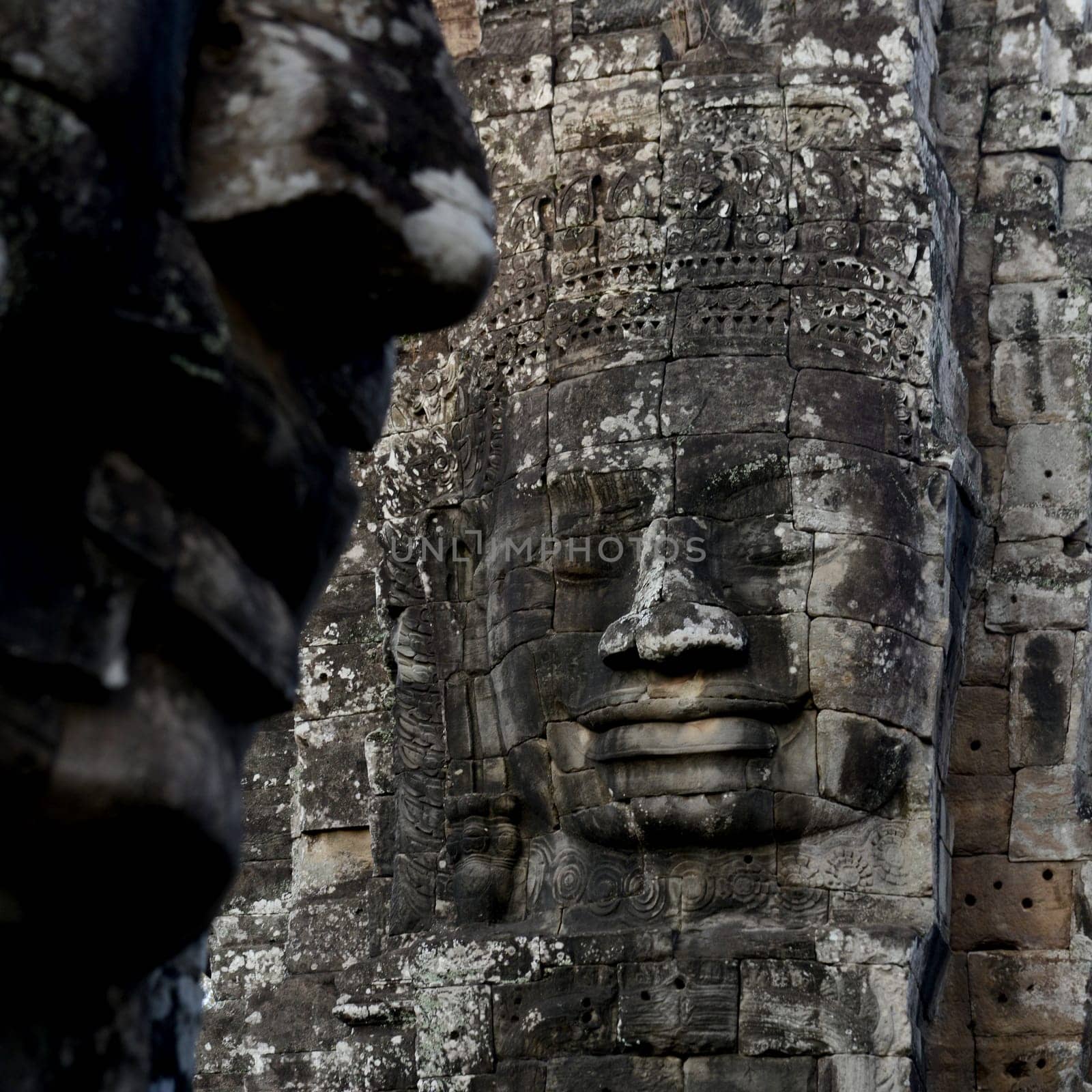 Stone Faces at the Bayon Temple the Tempel Ruins of Angkor Thom in the Temple City of Angkor near the City of Siem Reap in the west of Cambodia.  Cambodia, Siem Reap, April 2014