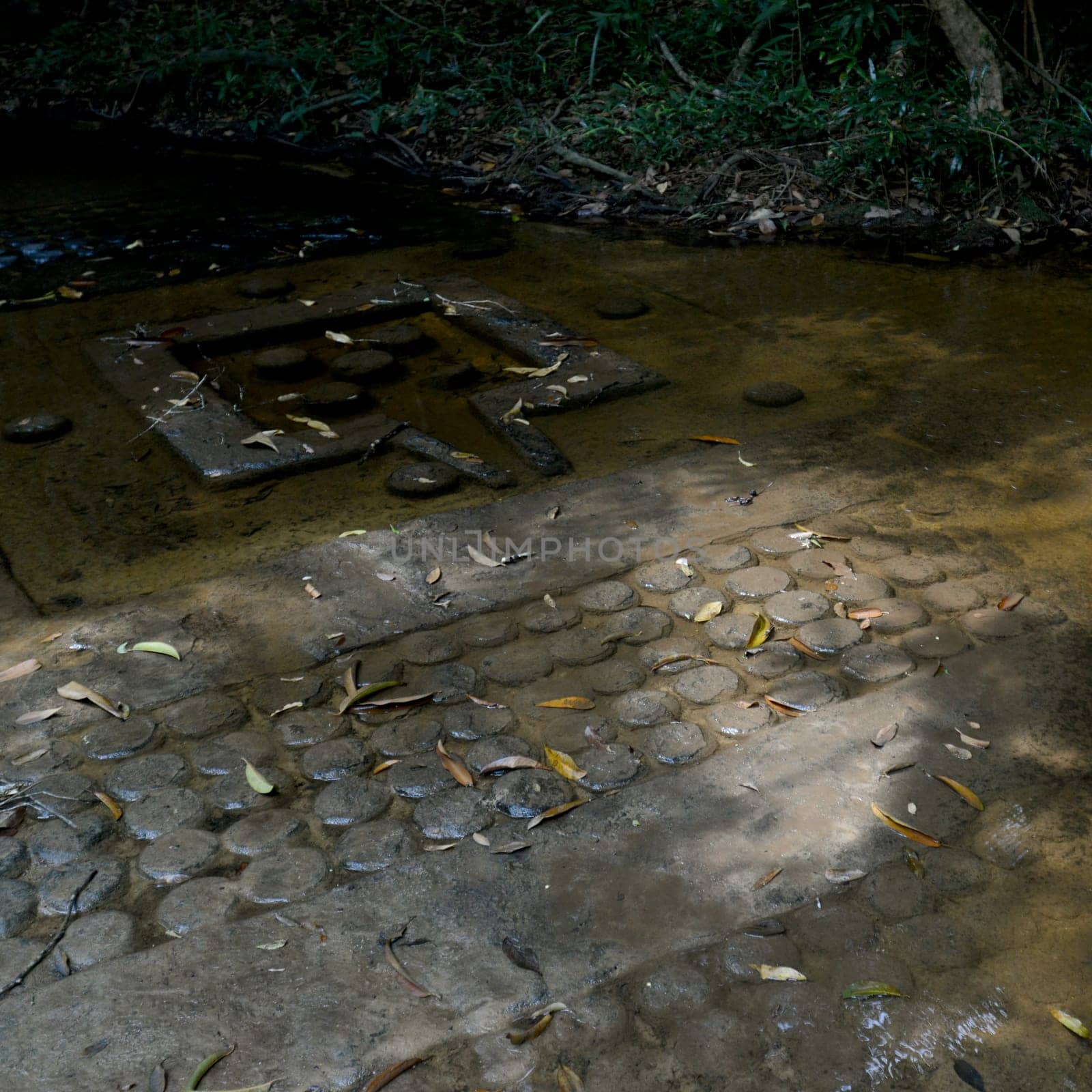 khmer stone carving at the river of a thousand lingas of  Kbal Spean 50 Km northeast of the Temple City of Angkor near the City of Siem Reap in the west of Cambodia.  Cambodia, Siem Reap, April 2014