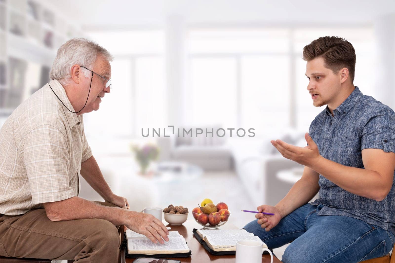Church servant counselor doing spiritual counseling to a young man studying the Bible