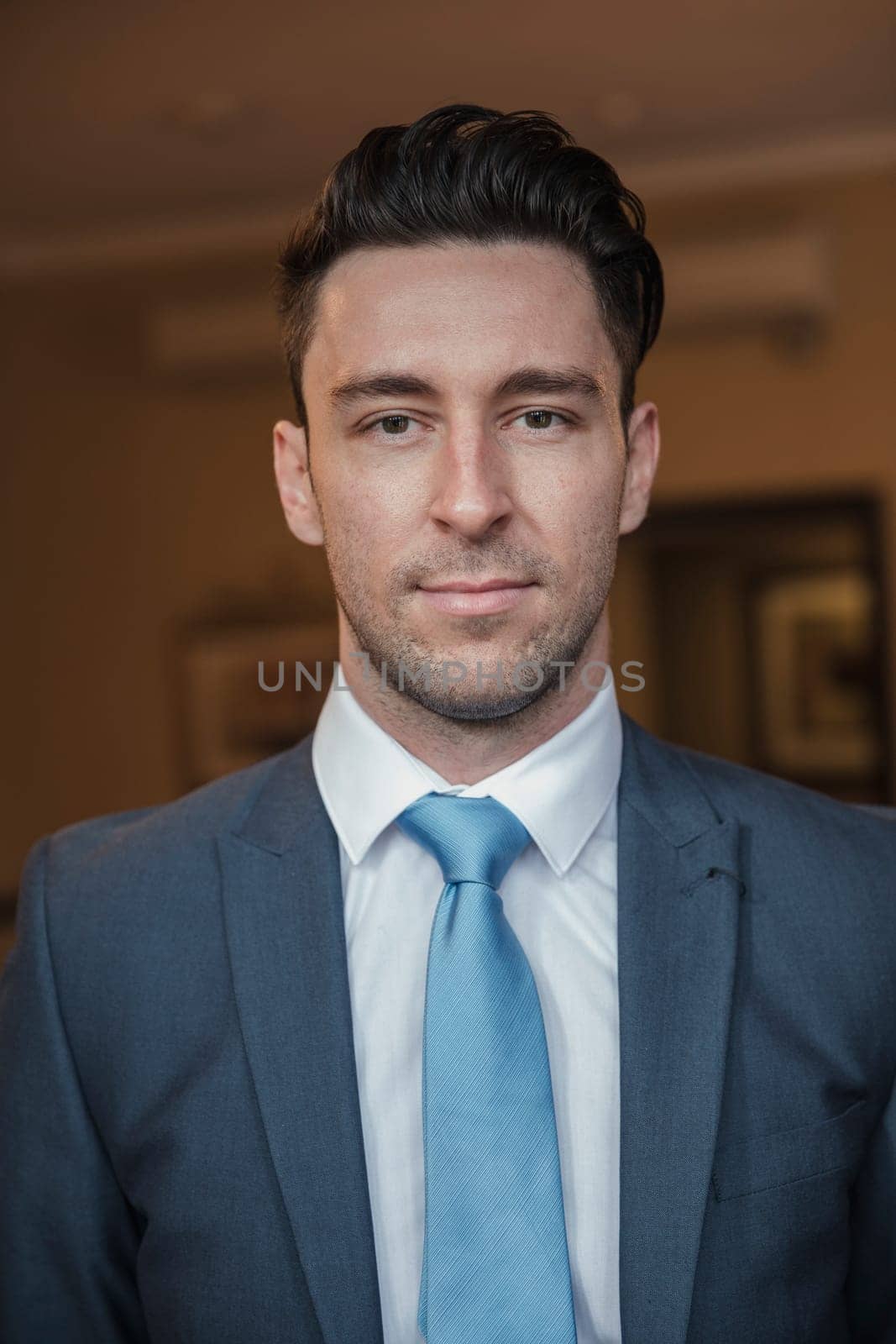 Front view of a young businessman giving a smile for the camera.