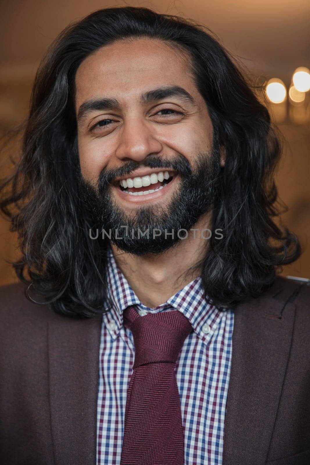 Front view of a young businessman giving a smile for the camera.
