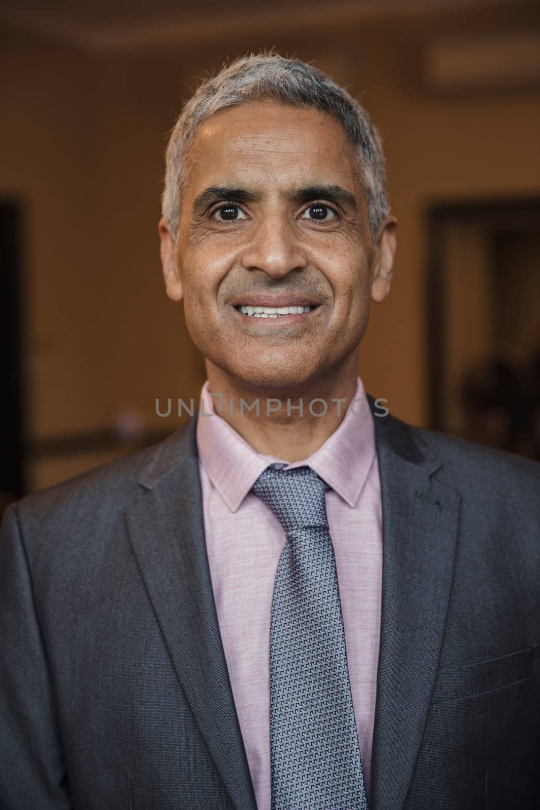 Front view of a mature businessman giving a smile for the camera.