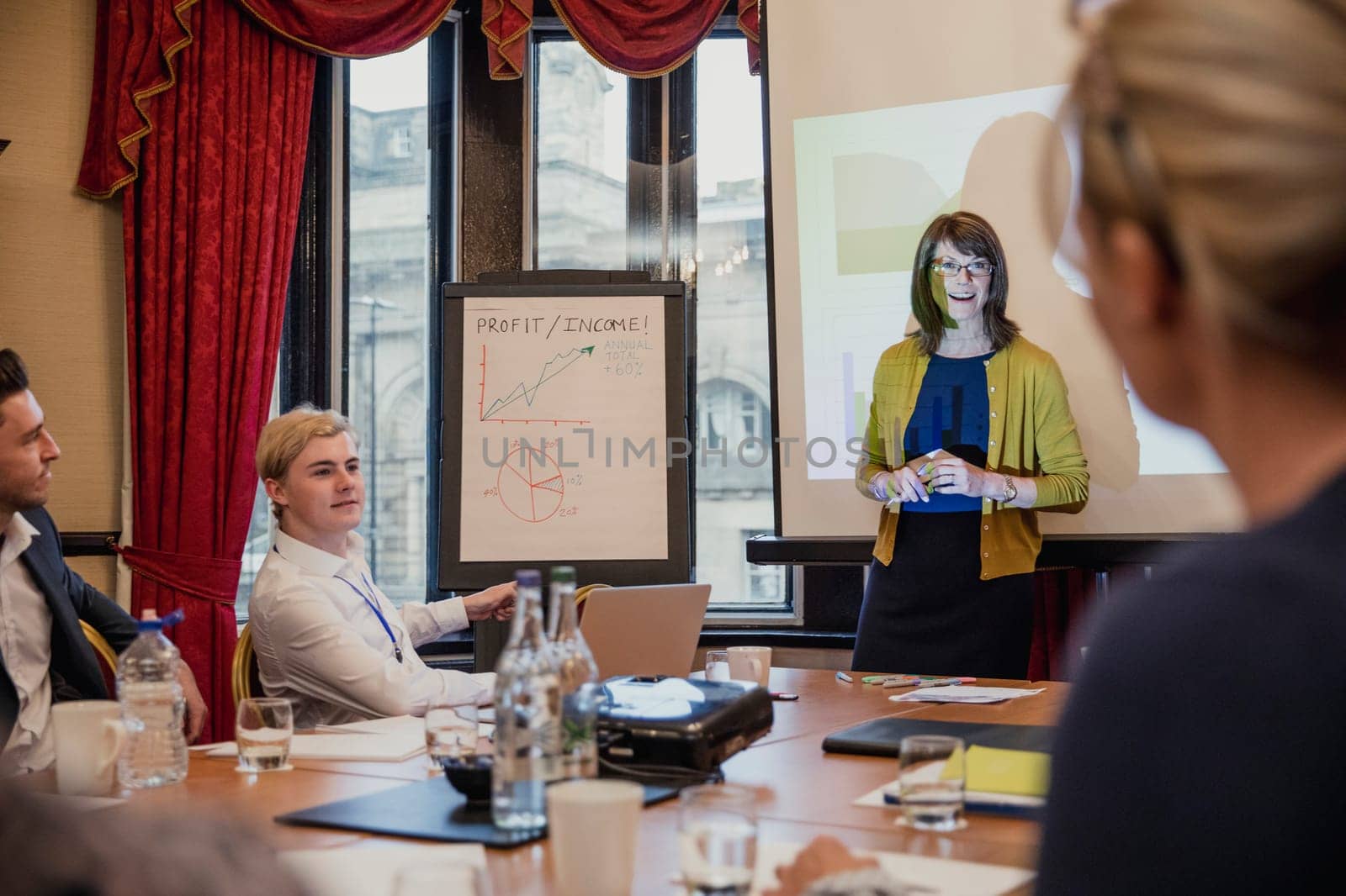 Point of view angle of a businesswoman giving a business presentation during a meeting.