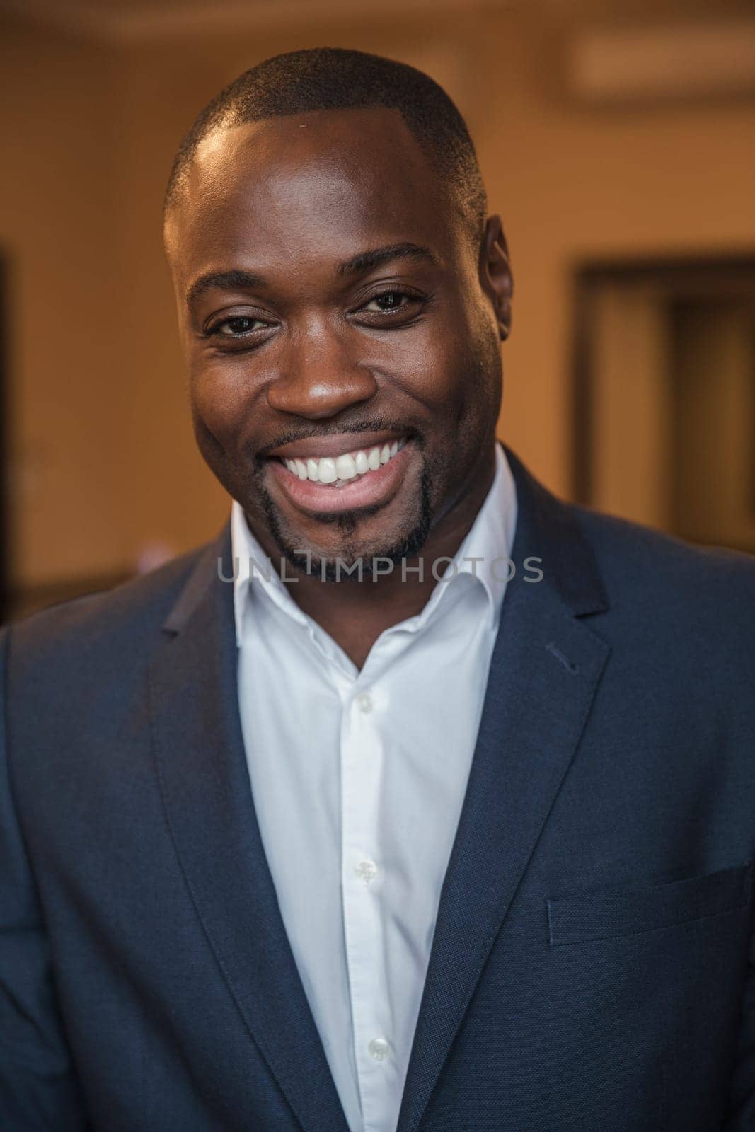 Front view of a young businessman giving a smile for the camera.