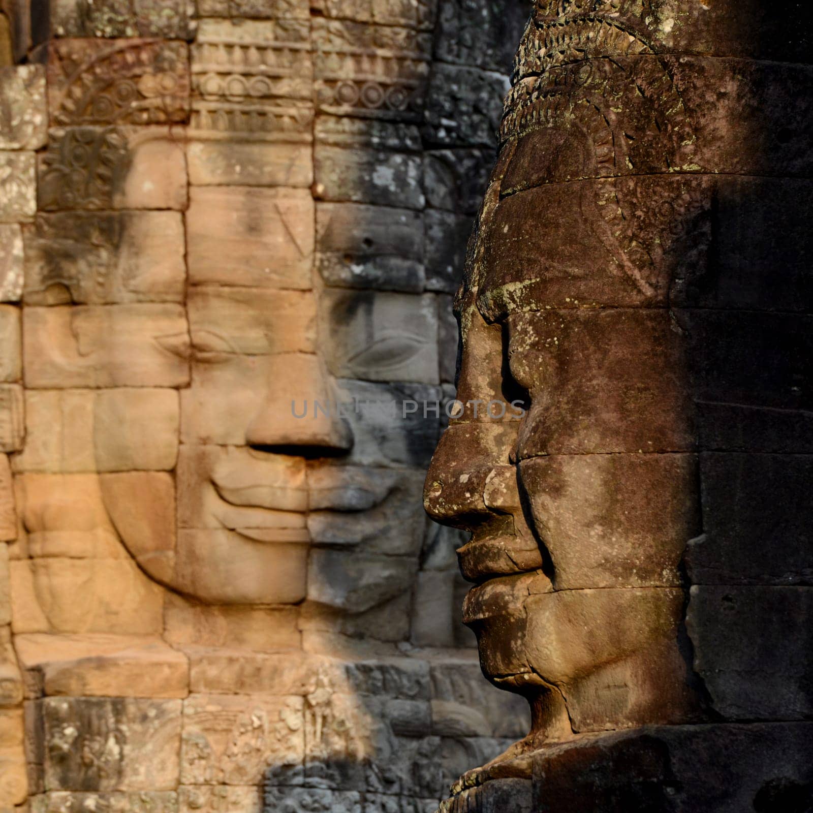 Stone face at the Bayon Temple the Tempel Ruins of Angkor Thom in the Temple City of Angkor near the City of Siem Reap in the west of Cambodia.  Cambodia, Siem Reap, April 2014