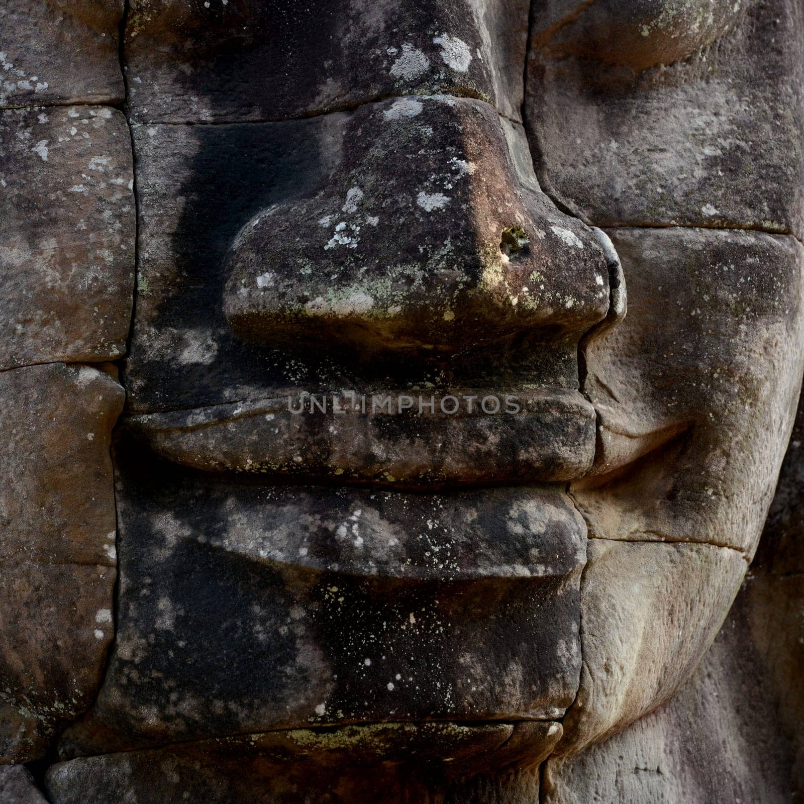 Stone face at the Bayon Temple the Tempel Ruins of Angkor Thom in the Temple City of Angkor near the City of Siem Reap in the west of Cambodia.  Cambodia, Siem Reap, April 2014