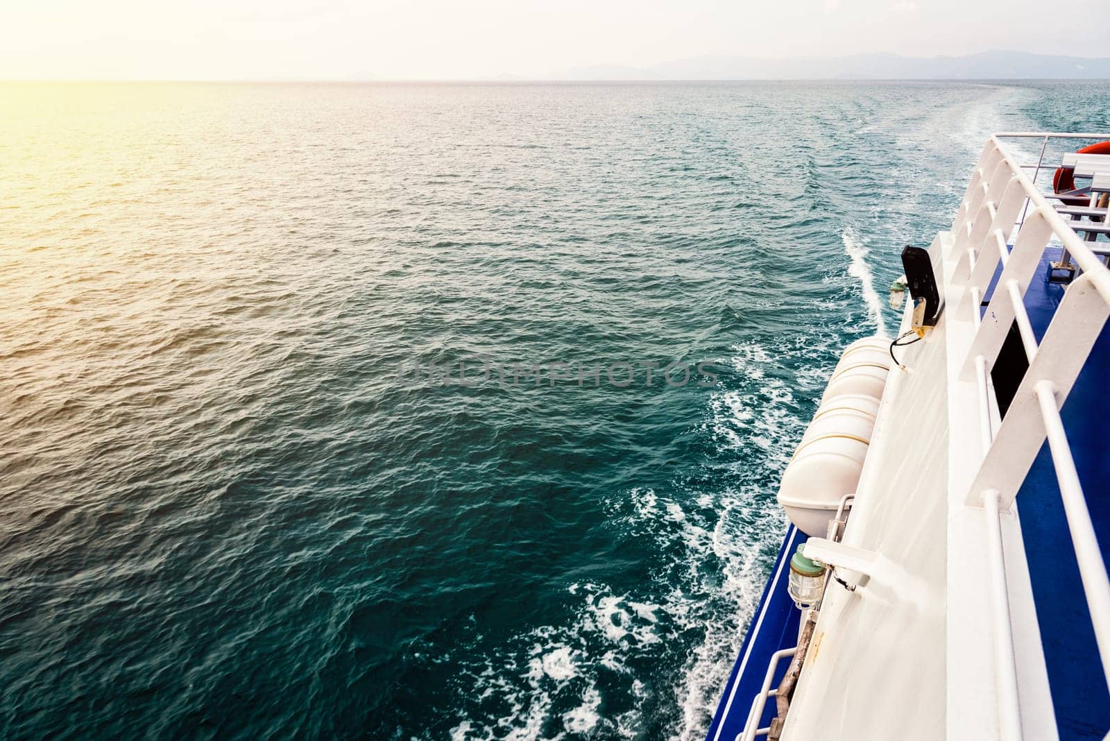 Travel boat sailing on the ocean during sunset in Thailand