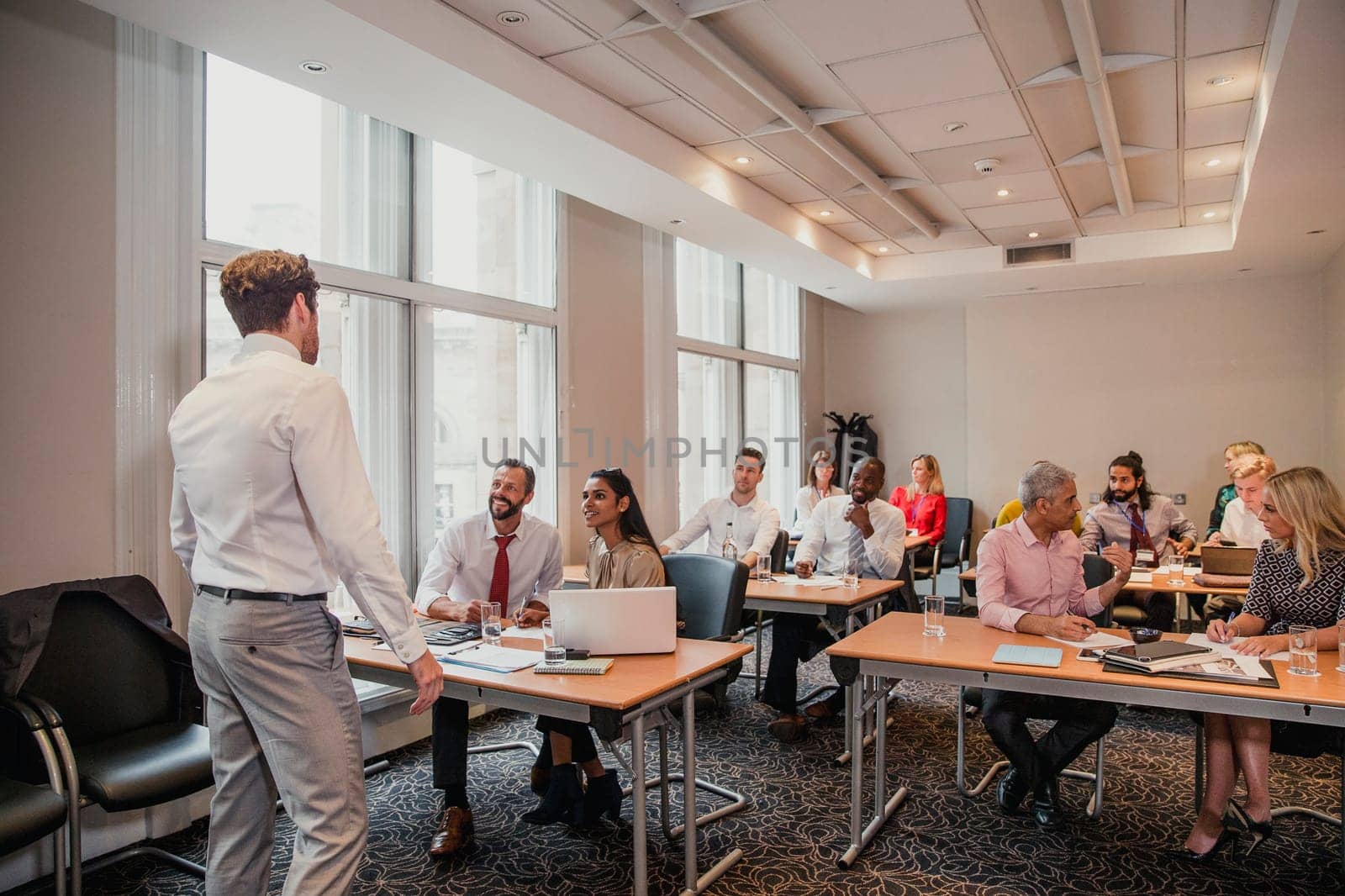 Rear view of an unrecognisable businessman giving a presentation at a conference.