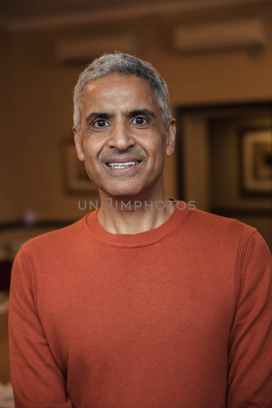 Front view of a mature male adult looking at the camera for a headshot.