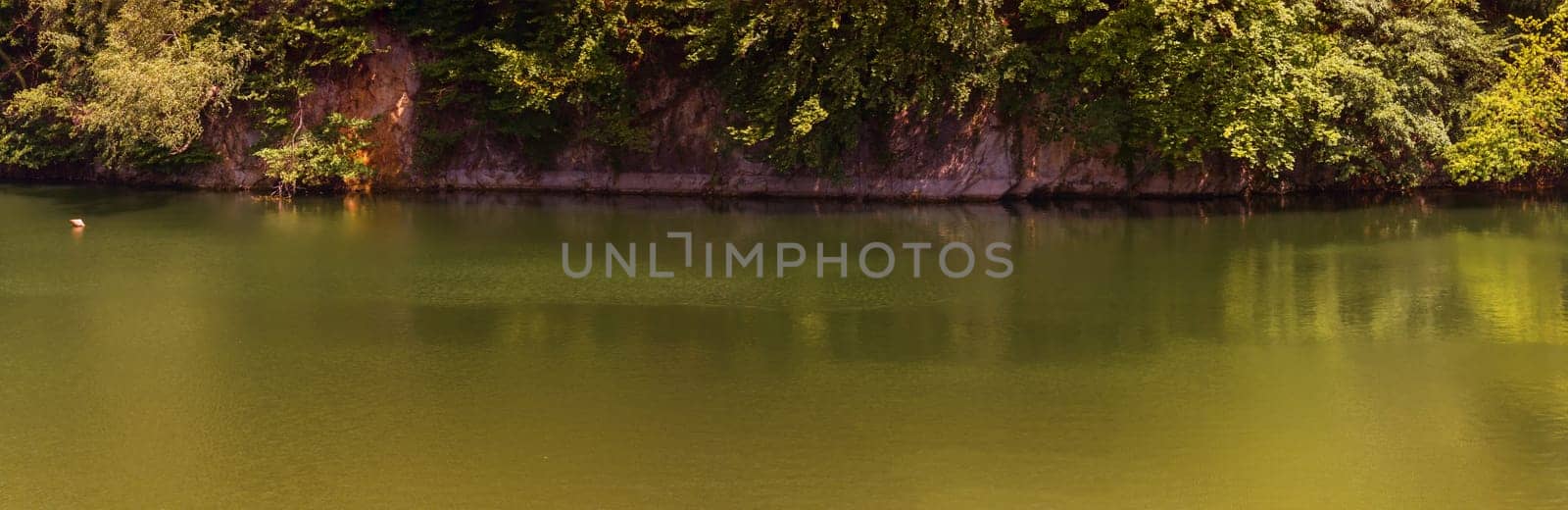 Lake with banks on the site of a former quarry for the extraction of limestone