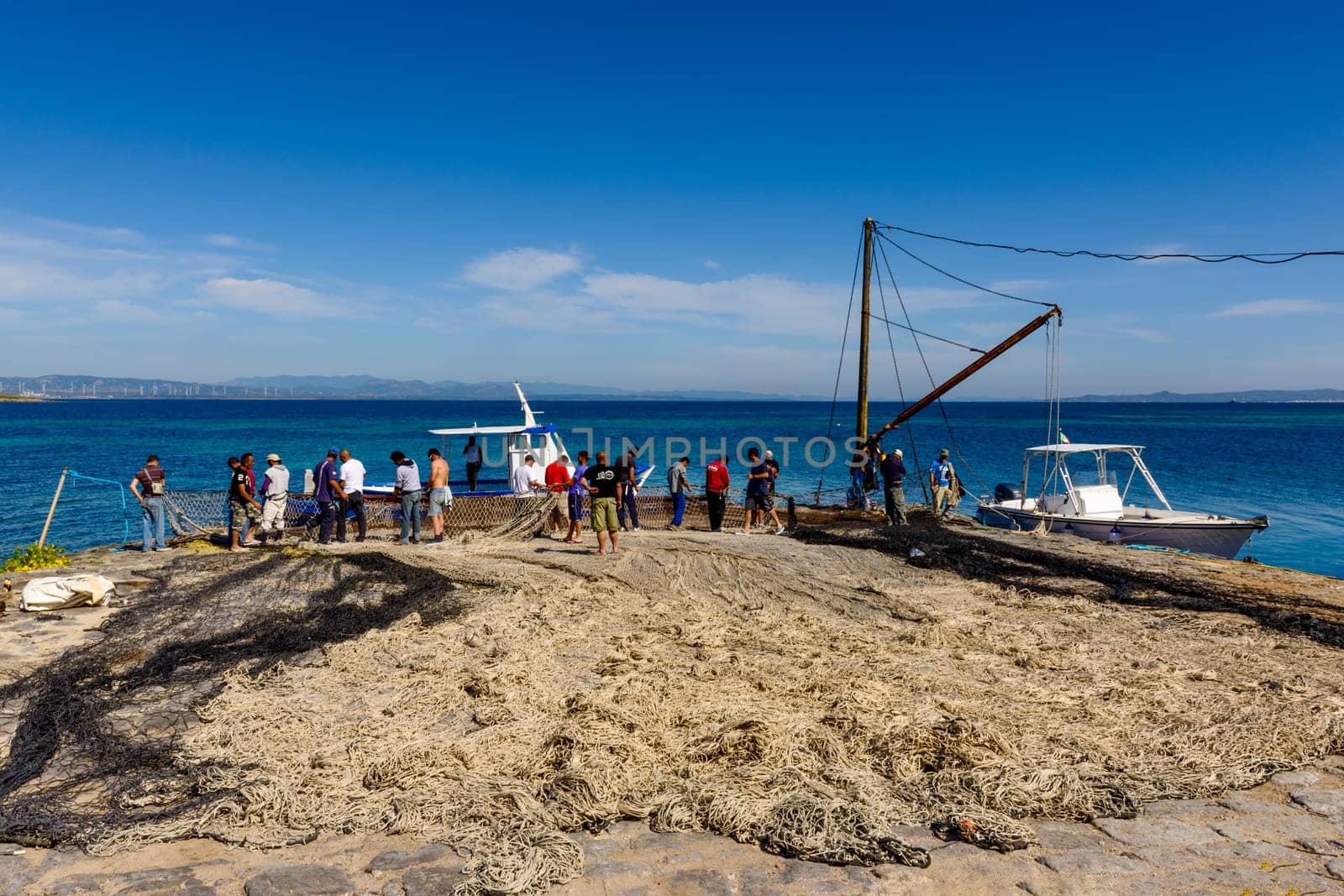 Carloforte, Island of San Pietro, Italy - 08 May 2014: "Mattanza"" is an ancient fishing technique based on nets. In Sardinia (southern Italy) there were many ""Tonnare"" to fish tuna in this way. The last active was the Tonnara of the island of San Pietro. In these scenes, fishing nets are prepared. the director of operations is called ""Rais""."