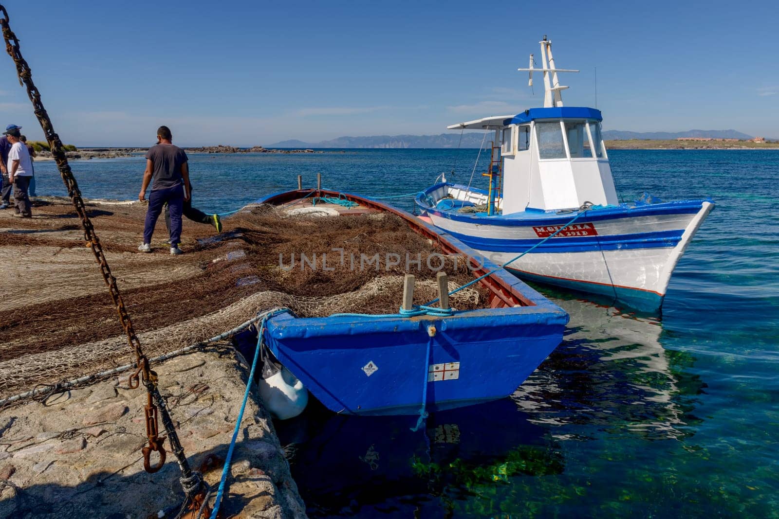 Carloforte, Island of San Pietro, Italy - 08 May 2014: "Mattanza"" is an ancient fishing technique based on nets. In Sardinia (southern Italy) there were many ""Tonnare"" to fish tuna in this way. The last active was the Tonnara of the island of San Pietro. In these scenes, fishing nets are prepared. the director of operations is called ""Rais""."