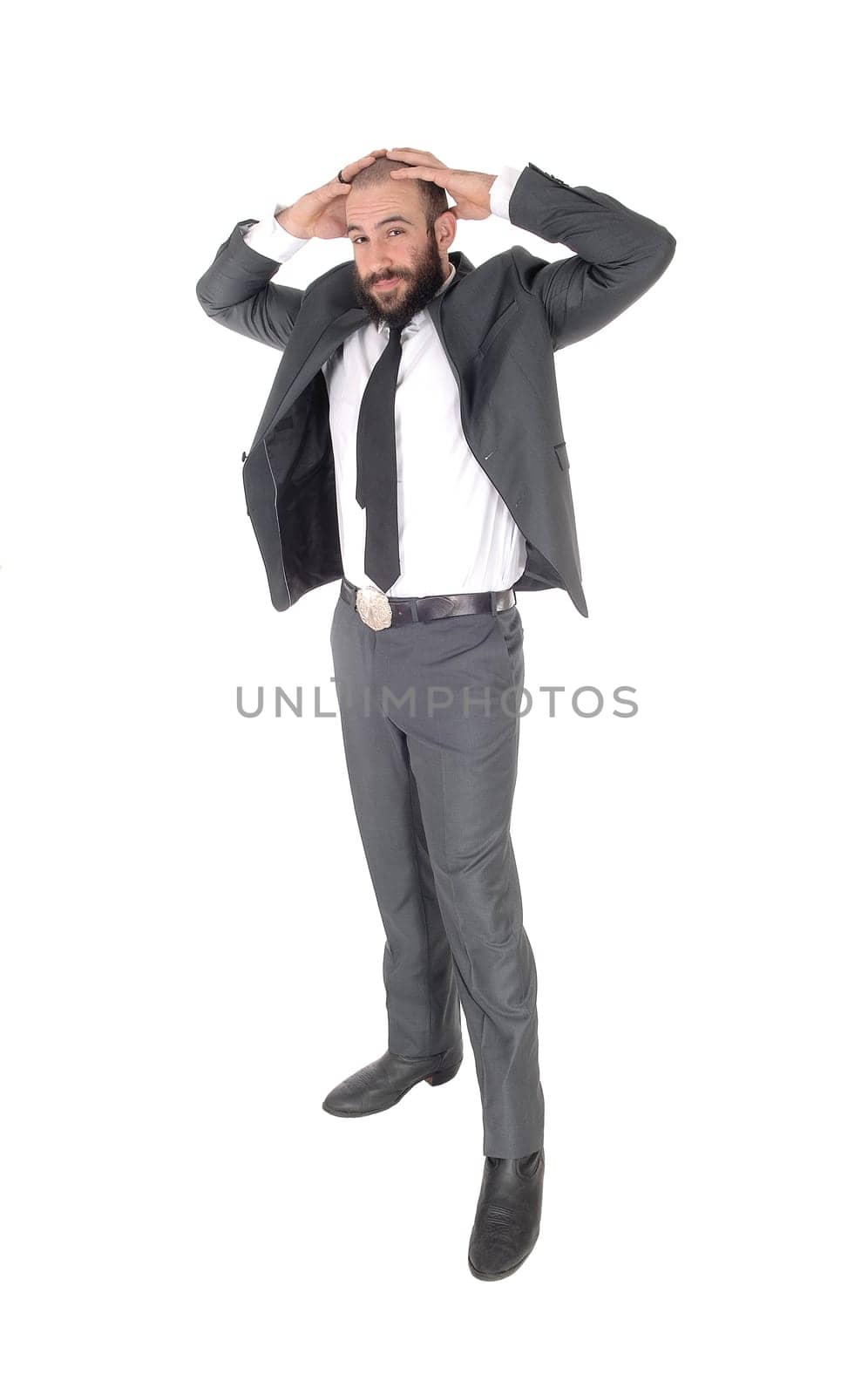 A handsome tall business man standing in a gray suit and tie holding.his hands behind his head, isolated for white background.