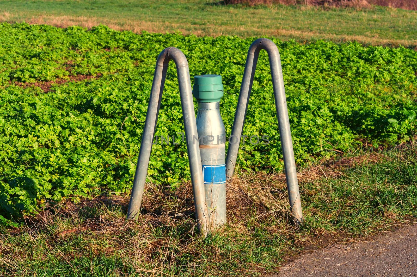 Ground water collection site on a field. Pipe with cover for checking groundwater.