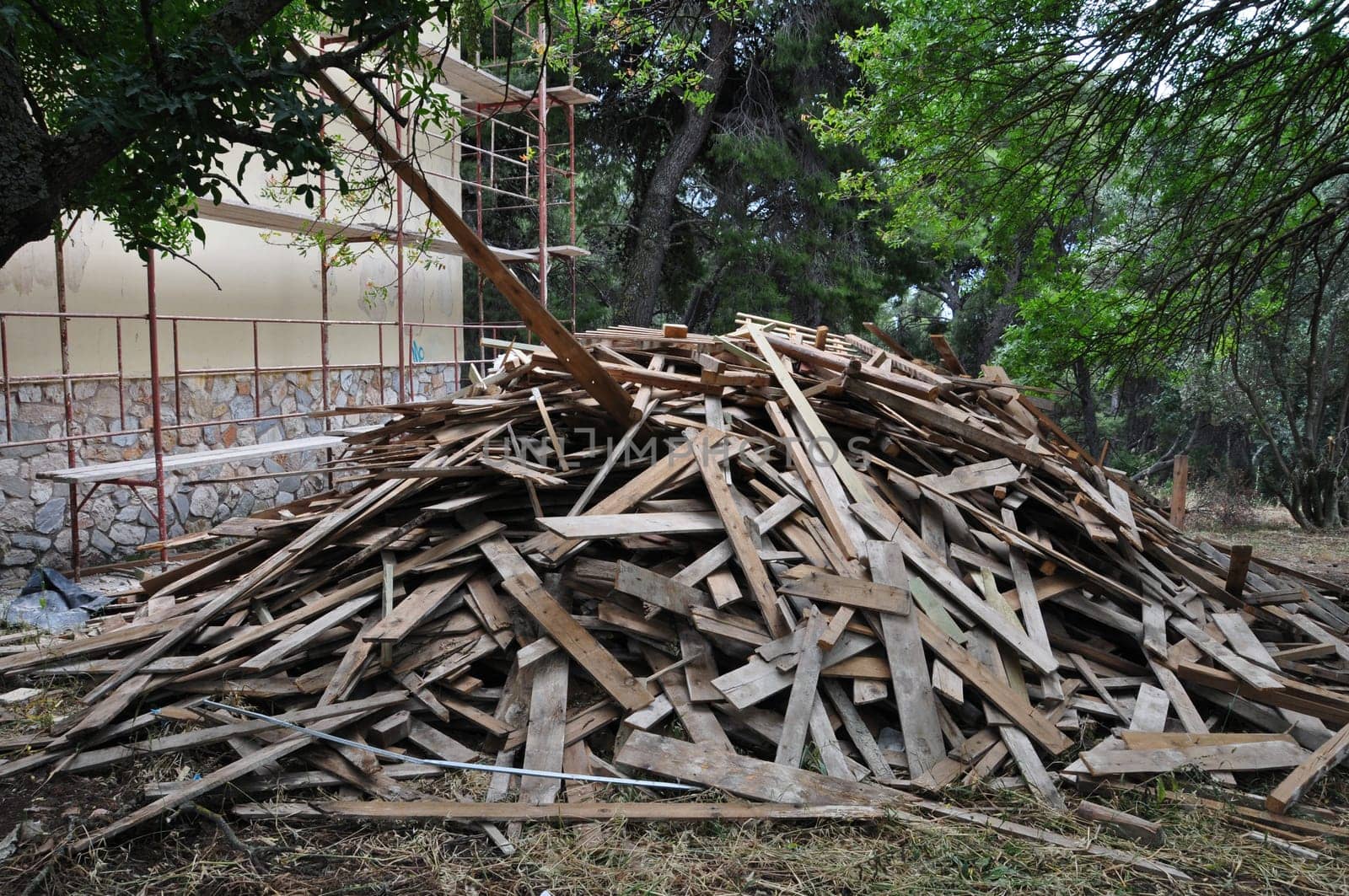 Big pile of old wooden planks at construction site.