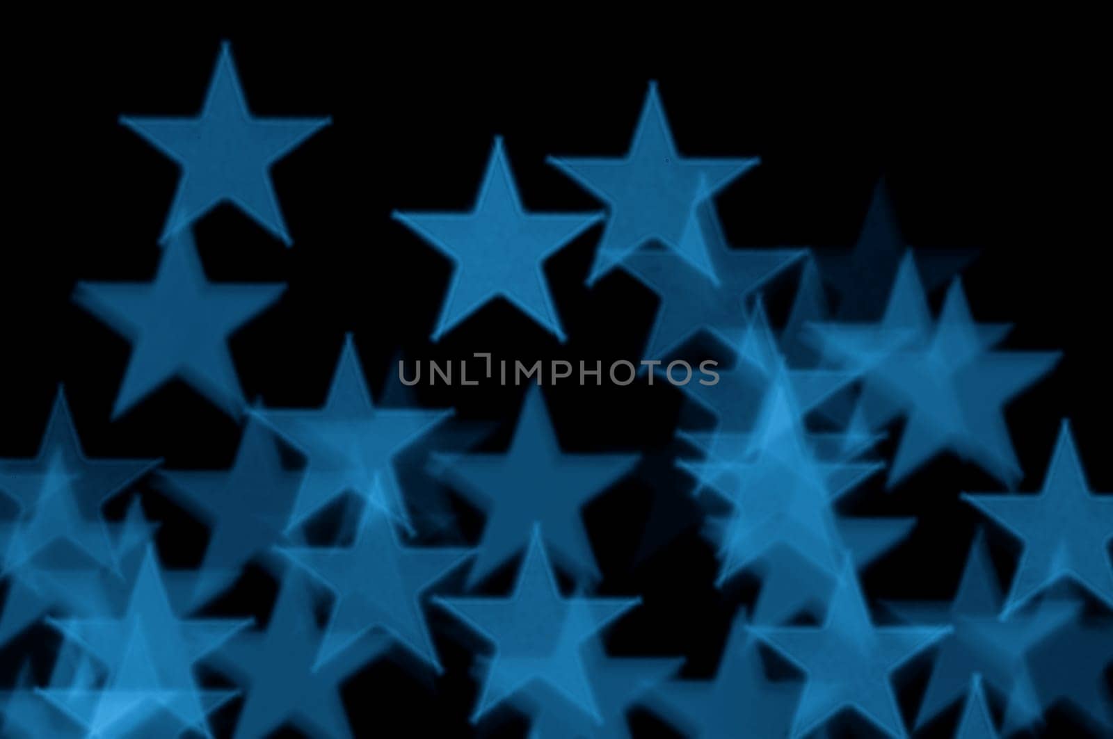 Blue stars pattern abstract blur on black background.